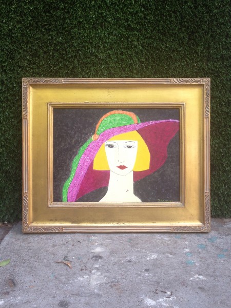gold framed painting of lady with hat