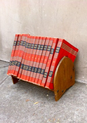 set of red vintage books with stand