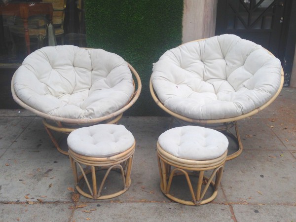 pair of round bamboo chairs with ottomans