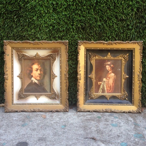 small framed portraits of man and woman