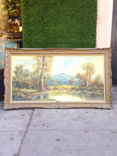 large framed painting of lake & trees