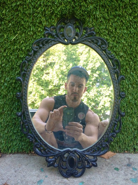 small oval mirror with heavy iron black frame