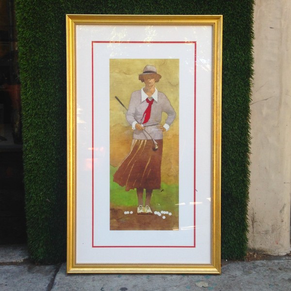 framed picture of lady playing golf