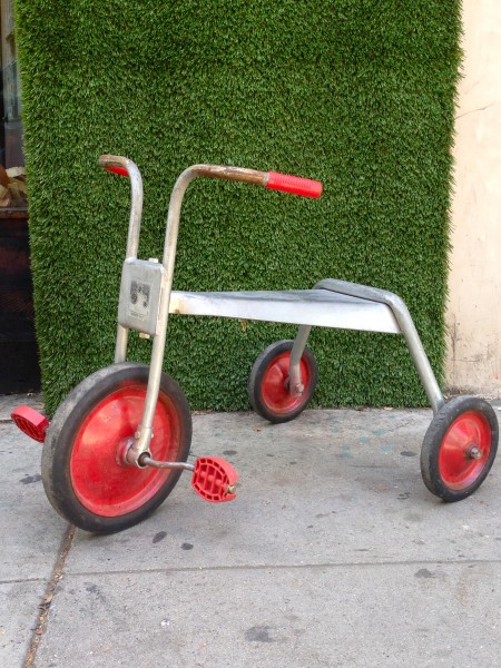 vintage metal tricycle with red wheels