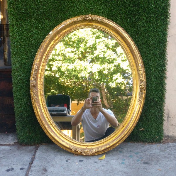 golden framed oval mirror