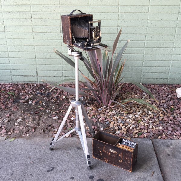 vintage camera on tripod with case and lenses