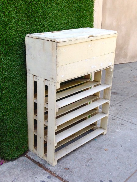 white wooden shelf with storage on top