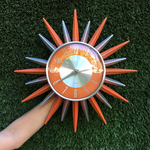 orange and silver starburst clock
