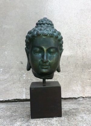small buddha head on stand