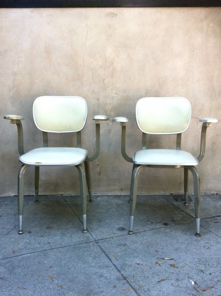 2 vintage industrial chairs with white leather seats