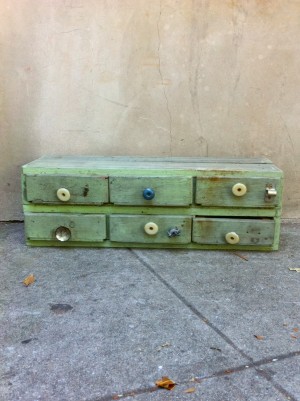 small green wooden 6-drawer piece
