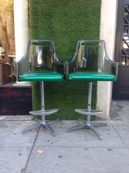 pair of vintage bar stools with green cushions